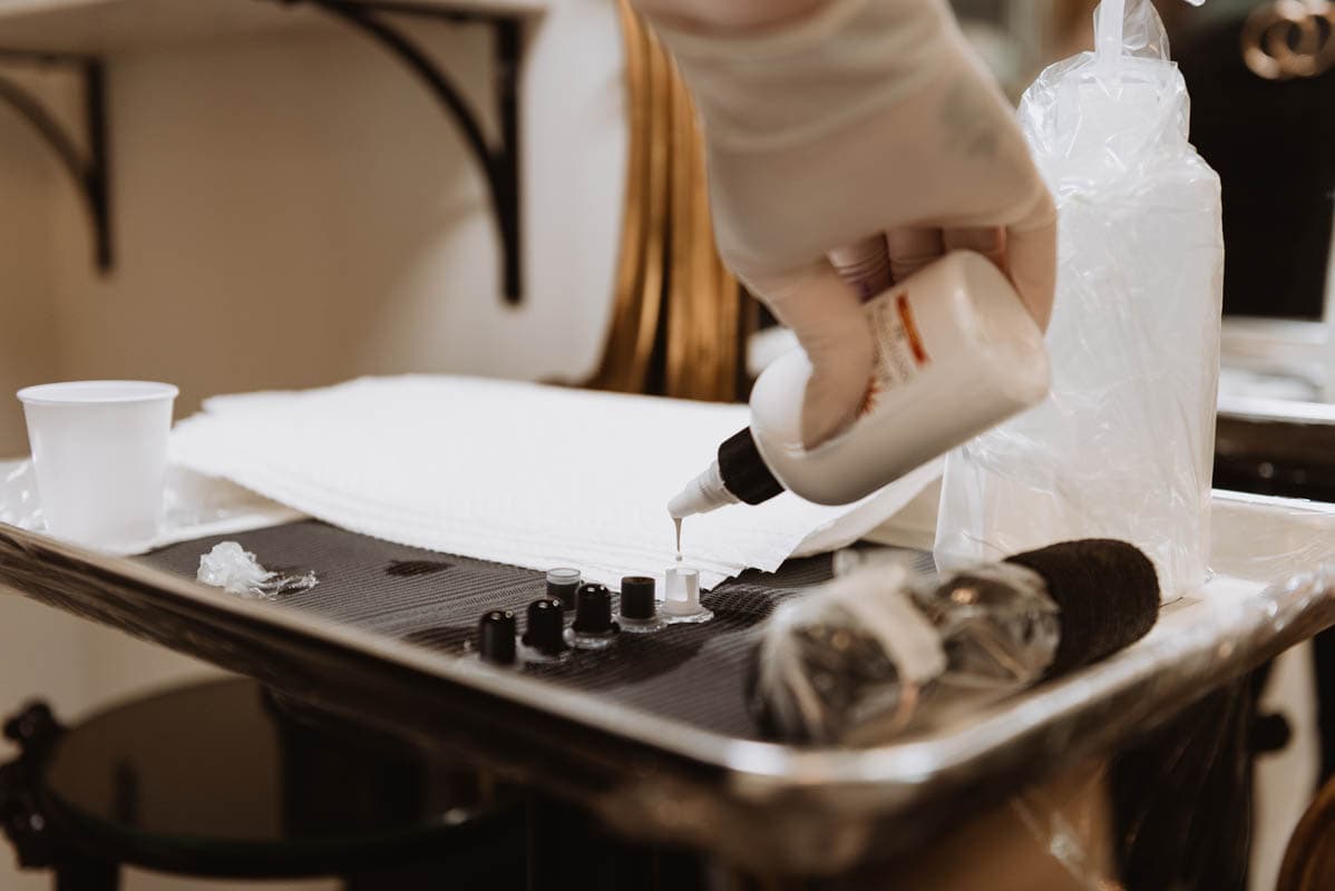 Tattoo artist pouring ink